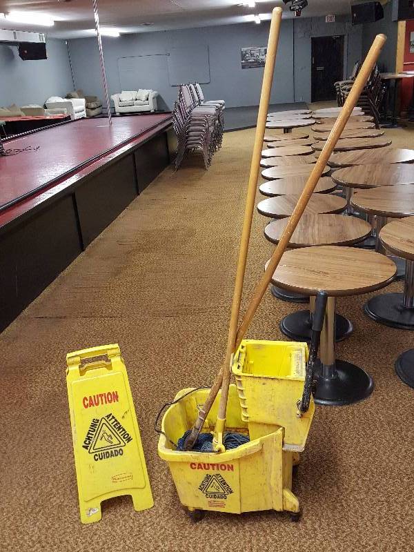 lot 215 image: Commercial Grade Mop Bucket, (2) Mops, and Caution Sign