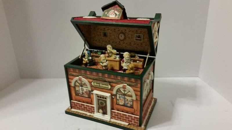 lot 127 image: Wind up Christmas Music Box which plays Santa Claus is Coming to Town When Opened While Figurines Move