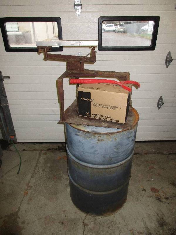 lot 79 image: clay pigeon thrower and box of clay pigeons w metal barrel stand