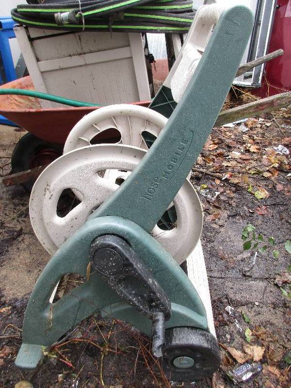 lot 93 image: 2 hose reels 2 hoses and wheelbarrow