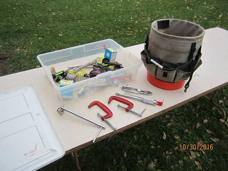 Plastic tote of tools and a tool bu...