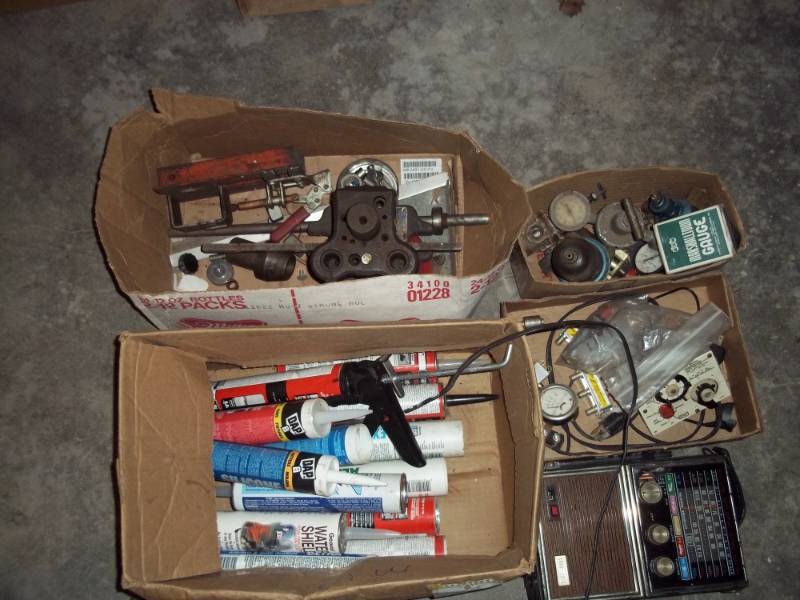 lot 172 image: Box of caulking, fuel bowls, radio, etc