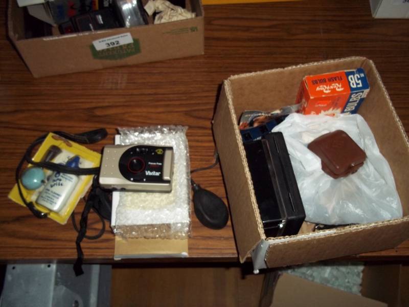 lot 394 image: Box of flash bulbs, lenses cleaning kits, camera