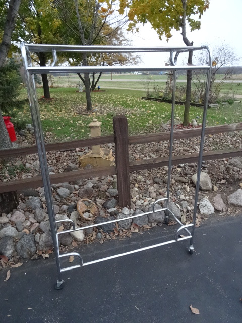 Clothing rack on wheels.