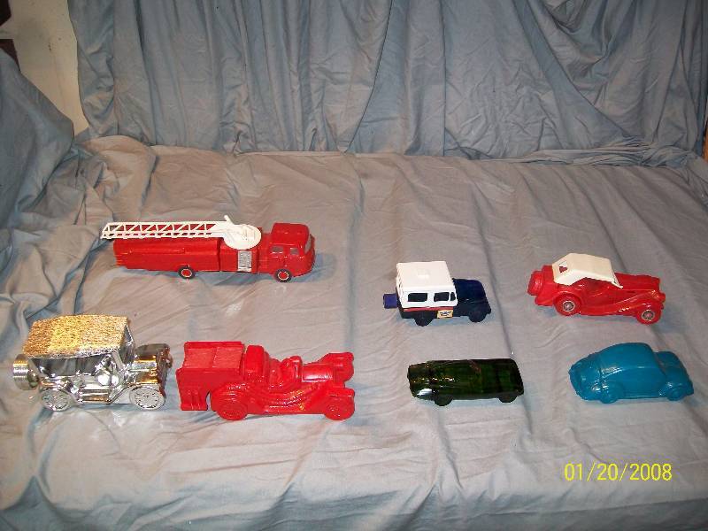lot 19 image: 7 Avon Vintage Collectible Cars with Labels.