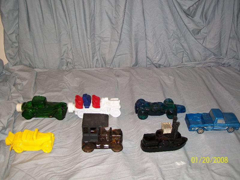 lot 21 image: 7 Avon Vintage Collectible Cars with Labels.