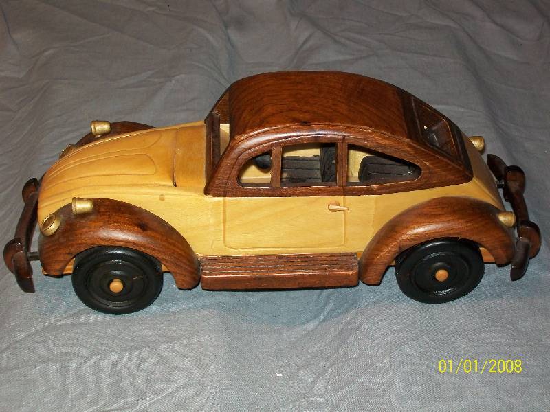 lot 29 image: Exquisite Multi Wood Touring Model Car with opening Front Trunk & Wooden Wheels.