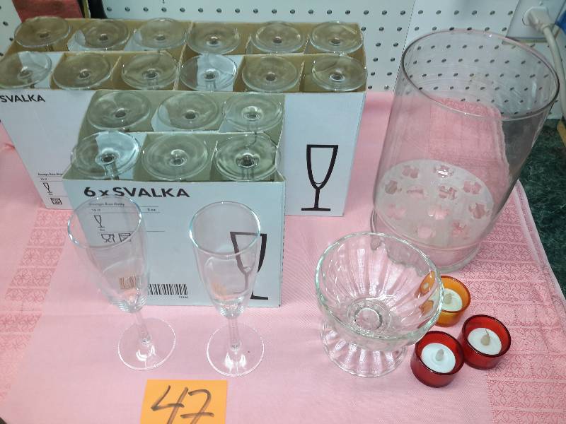 lot 47 image: 20 Champagne Glasses from IKEA.. 1 Tulip forcer.. 1, 30s40s shrimp cocktail bowl.. 3 votive candles