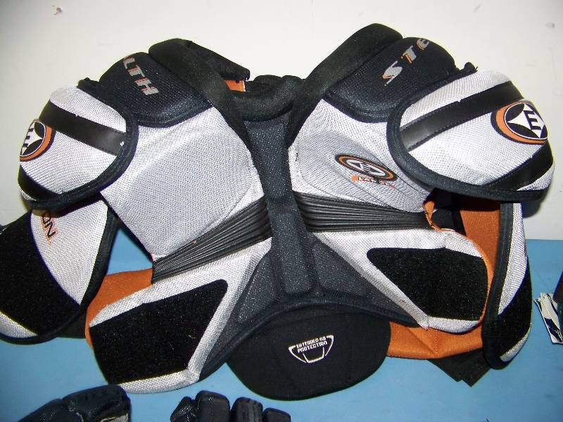 lot 33 image: (2 pair) Hockey Shoulder  Chest Pads and (3 pair) Hockey Gloves