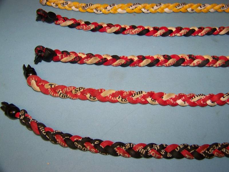 lot 37 image: (8) Sports Titanium, Baseball Necklaces