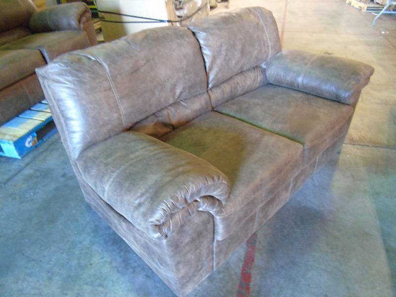 lot 29 image: Ashley Furniture Bladen Leather-Look Loveseat - Coffee Color