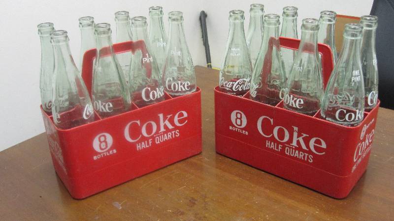 lot 44 image: Two vintage plastic 8 pack Coca Cola carriers with empty 1 pint bottles