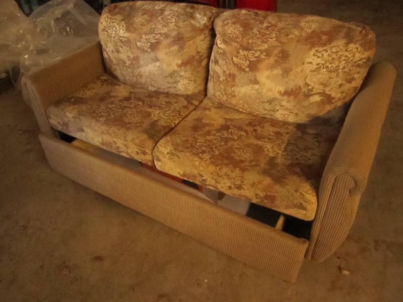 lot 69 image: RV couch, folds into a bed with sto...