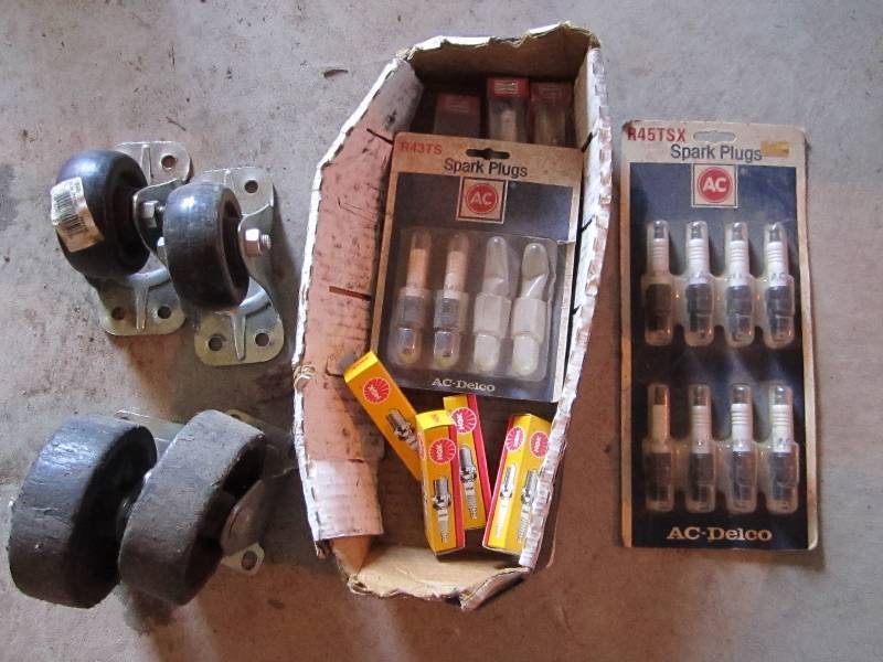 lot 93 image: Lot of spark plugs and caster wheel...