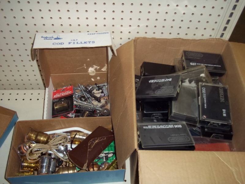 Box of plastic storage cases, box of lamp parts, box of hardware