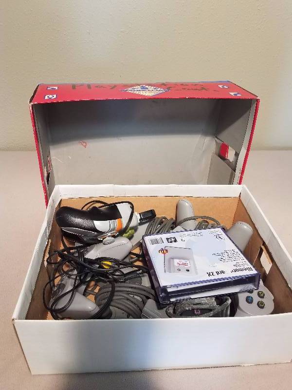 Box of PlayStation and Game Controls