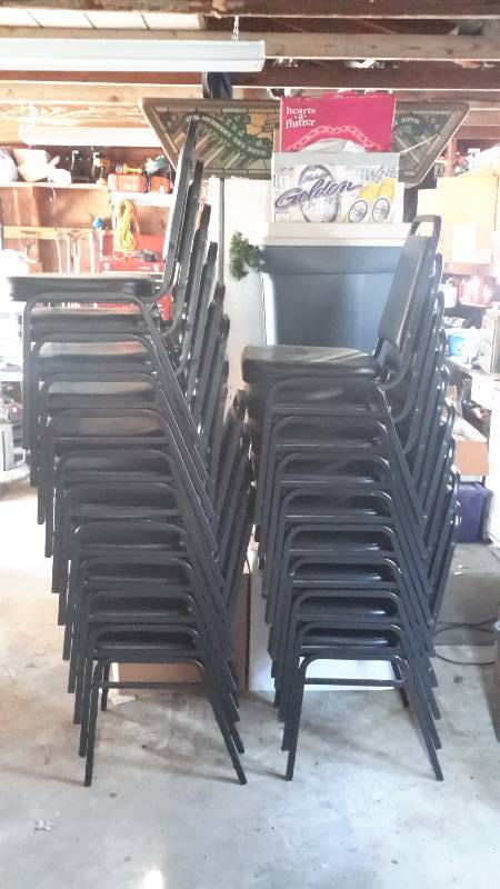 Set of stackable dining chairs. 26 in total all black in color