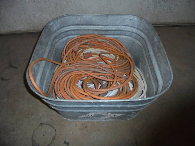 lot 65 image: Tub with (2) 25ft & (2) 50ft Extension Cords