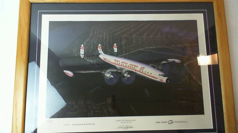 lot 519 image: Home for the Holidays Dec 24th, 1956 The Ambassador TWA Super G Constellation by Mike Machat framed signed Limited Edition airplane art print #900 of 1049