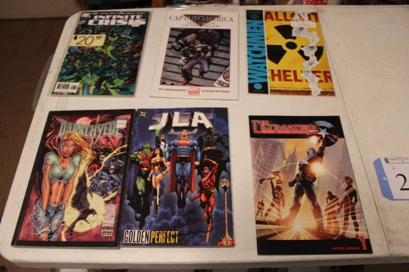lot 24 image: Lot of (6) Marvel, DC, Watchmen Comics The Ultimates, JLA, Dark Hyde, Infinite Crisis, Captain America, Fallout Shelter Comic Books w Signed