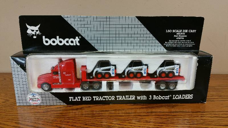 lot 32 image: Melroe Ingersoll-Rand Bobcat Flat Bed TractorTrailer