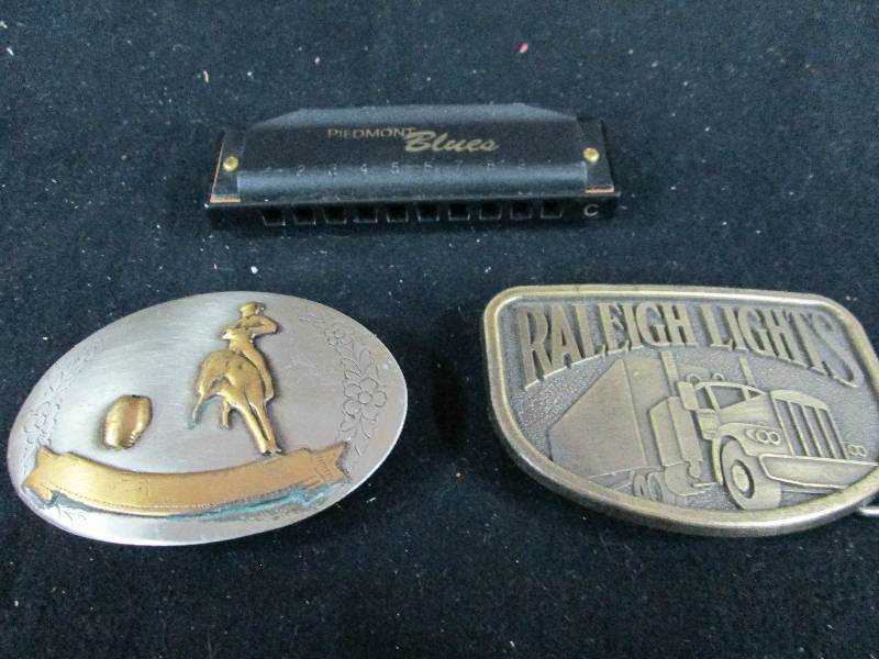 lot 179 image: Belt Buckles and Harmonica