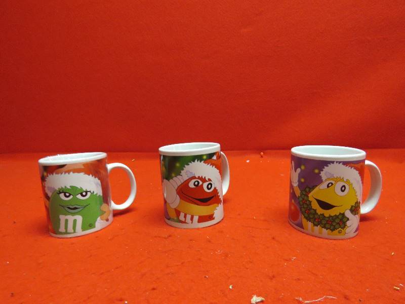 lot 17 image: M&M Collectible Christmas Mugs