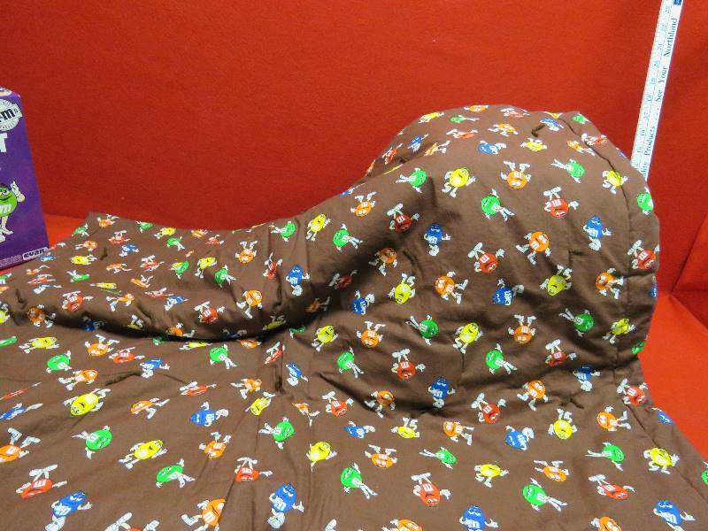 lot 82 image: Handmade M&M Baby Quilt