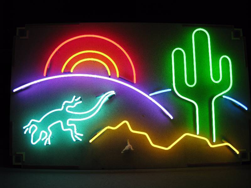 lot 8 image: Southwestern desert scene complete with neon gecko, saguaro cactus and 3D skull. Aluminum frame wall hanging art.