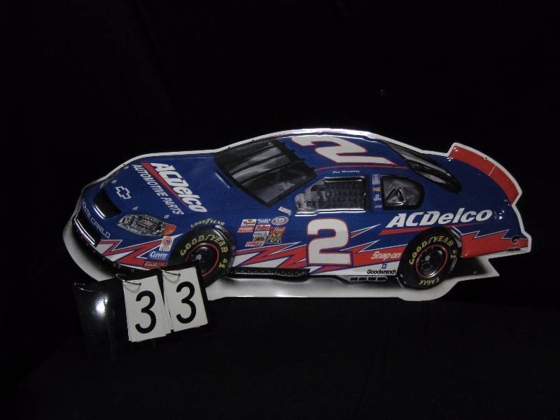 lot 33 image: AC Delco  NASCAR die cut embosed tin tacker. Looks new.