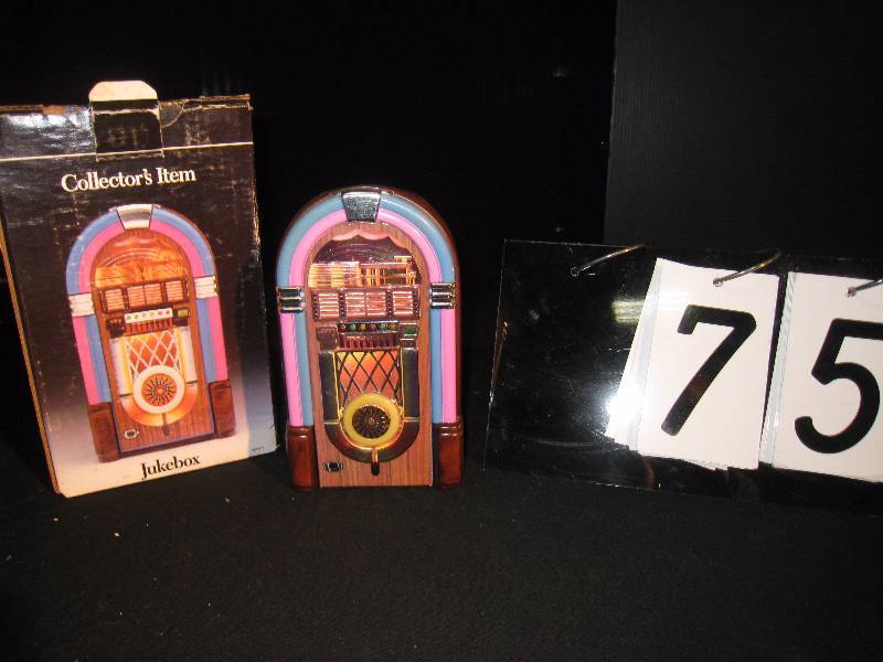 lot 75 image: Jim Beam handcrafted jukebox decanter plays classic rock and roll NOS New Old Stock, seal not broken - contains 750 ML of Fine Beam Bourbon.
