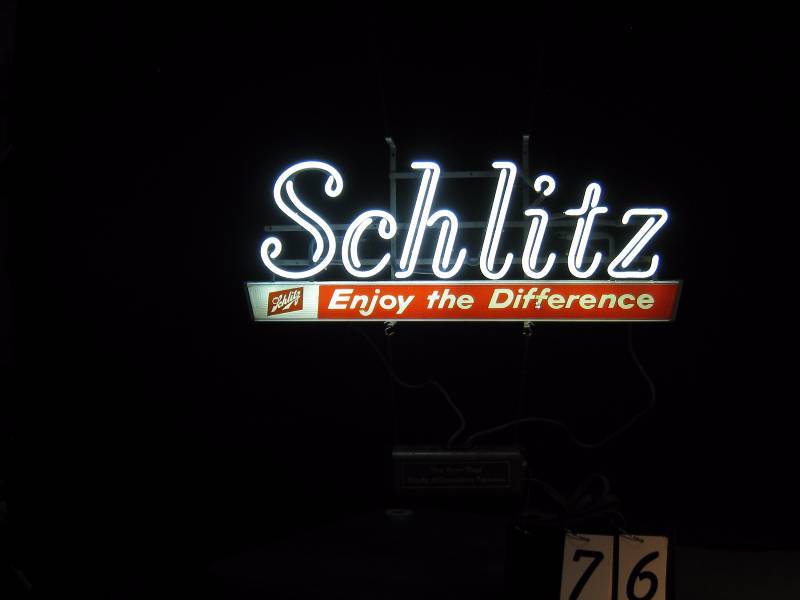 lot 76 image: Schlitz 1960s neon sign. Everything is beautiful about this sign, even the cool and unusual chain.
