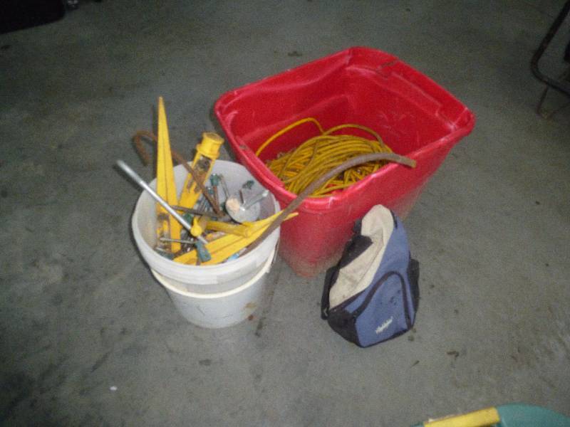Tote of Extension cords and Stakes