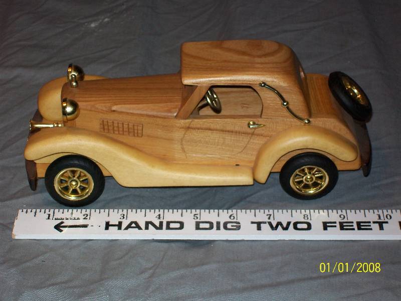 lot 30 image: Exquisite Multi Wood Touring Model Car with Rubber Wheels. 10 long
