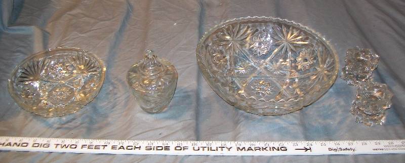lot 64 image: 6 Piece Early American Prescut Clear Glass Star Collection Includes Serving Bowls, Sugar Bowl with Cover, Candle Holders.