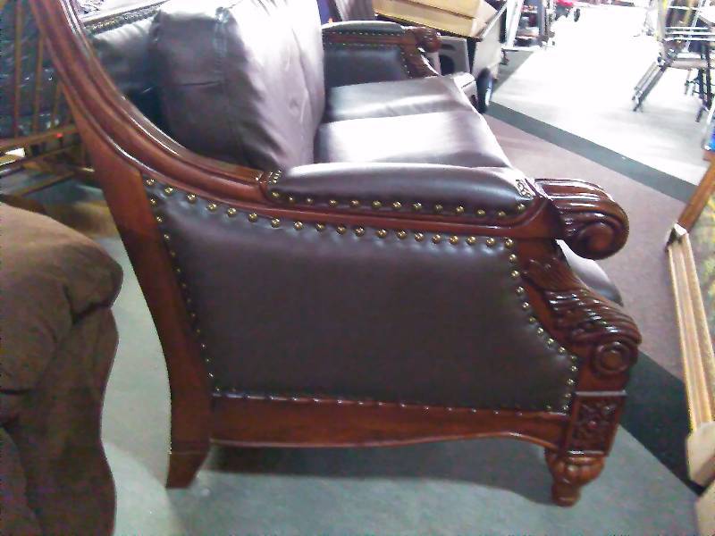 lot 146 image: Leather Sofa with Wood intricate wood Carving