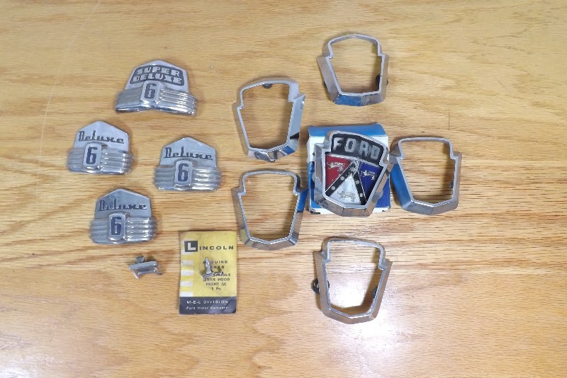 lot 21 image: Lot of Vintage Ford Deluxe 6, Super Deluxe 6 Hood Ornaments, etc.