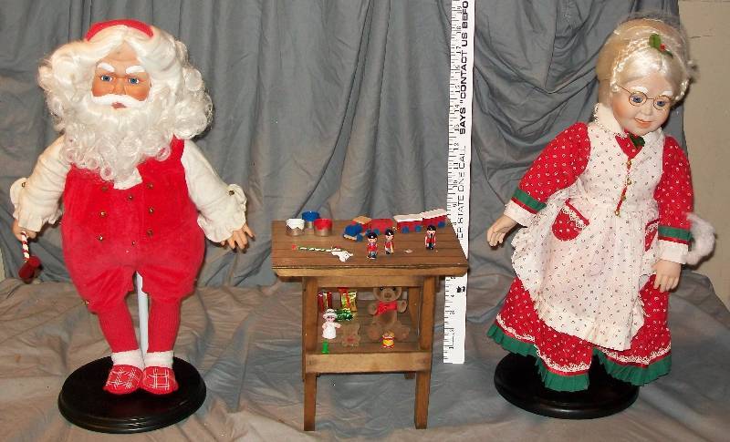 lot 13 image: 20 Tall Father ChristmasSanta Claus 1988 and Mrs Claus 1989 MBI on stands with Toy Work Bench