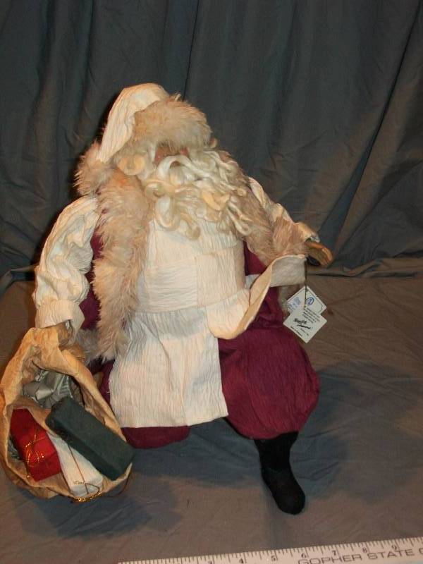 lot 45 image: Mache Mystique. Possible Dreams. Kneeling Father ChristmasSanta Claus with Gift Bag.