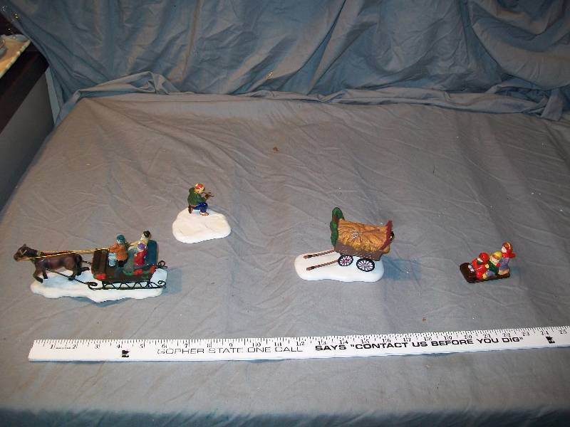 lot 58 image: 4- piece lot 3- Dept 56 (Haywagon, Boy kneeling, & kids on Sled) 1- Horse Pulled Sleigh Ride