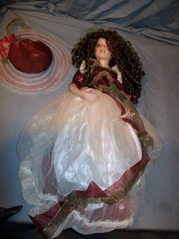 lot 60 image: 23 Victorian Styled Collectible Finely Detailed Doll with Exquisite Victorian DressClothing. Doll has Porcelain Face