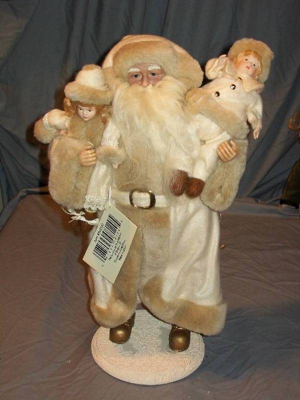 lot 79 image: 16 Vintage The Santas by Tina Mitchell - White Faux Fur Father ChristmasSanta Claus carrying Dolls
