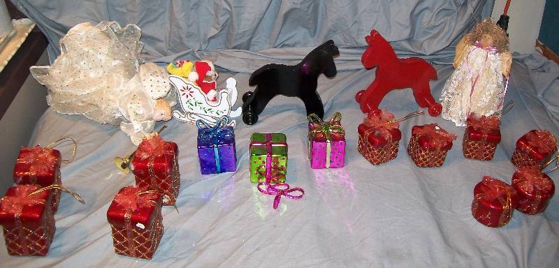lot 105 image: Assorted Christmas & Under Tree Decorations plus 1- Tree Hugging Angel & 1- Tree Topper. See Pictures