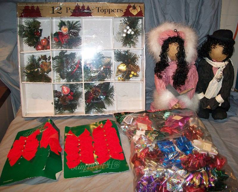 lot 111 image: Assorted Lot of 9 Woodsy Package Toppers, Red Ribbons, Large Bag of Bows, & 2- Faceless Carolers