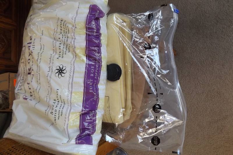 lot 285 image: Down pillow and yellow blanket in storage bag