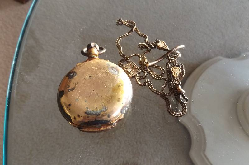 lot 456 image: Gold colored pocket watch and watch chain, crystal is missing