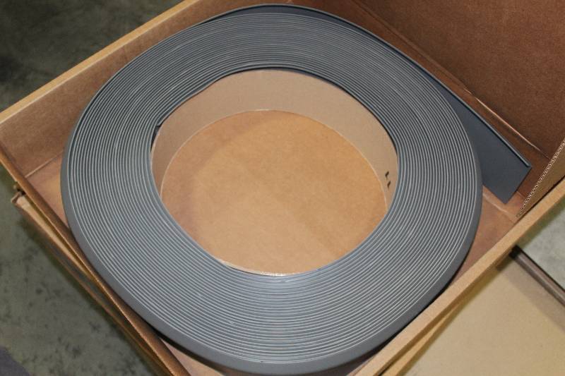 lot 142 image: Pallet Lot of (5) Boxes of 120ft. Flexco Graphite Rubber 18in. Coil Baseboard