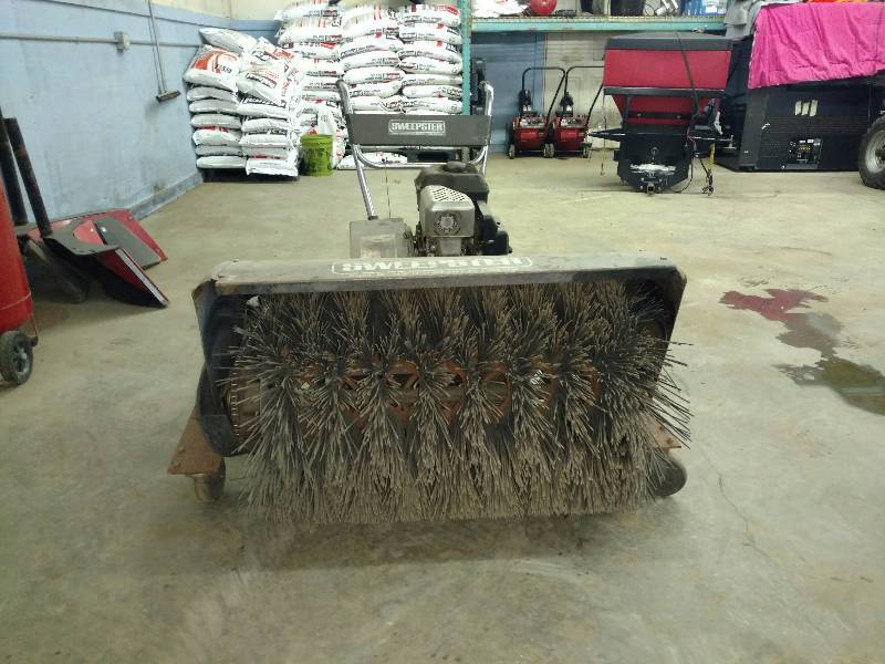lot 1F image: 5.5HP Stand Behind Sweepster. OHV. Briggs Stratton