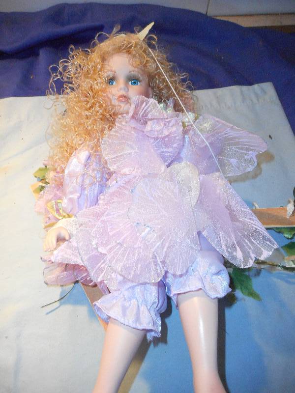 lot 28 image: PORCELAIN FAIRY DOLL