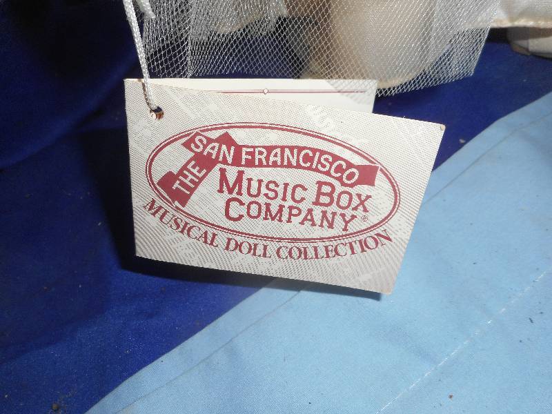lot 63 image: MUSIC BOX CO. PORCELAIN DOLL
